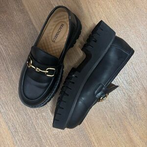 Black chunky platform loafers with gold ornament, size 5.5